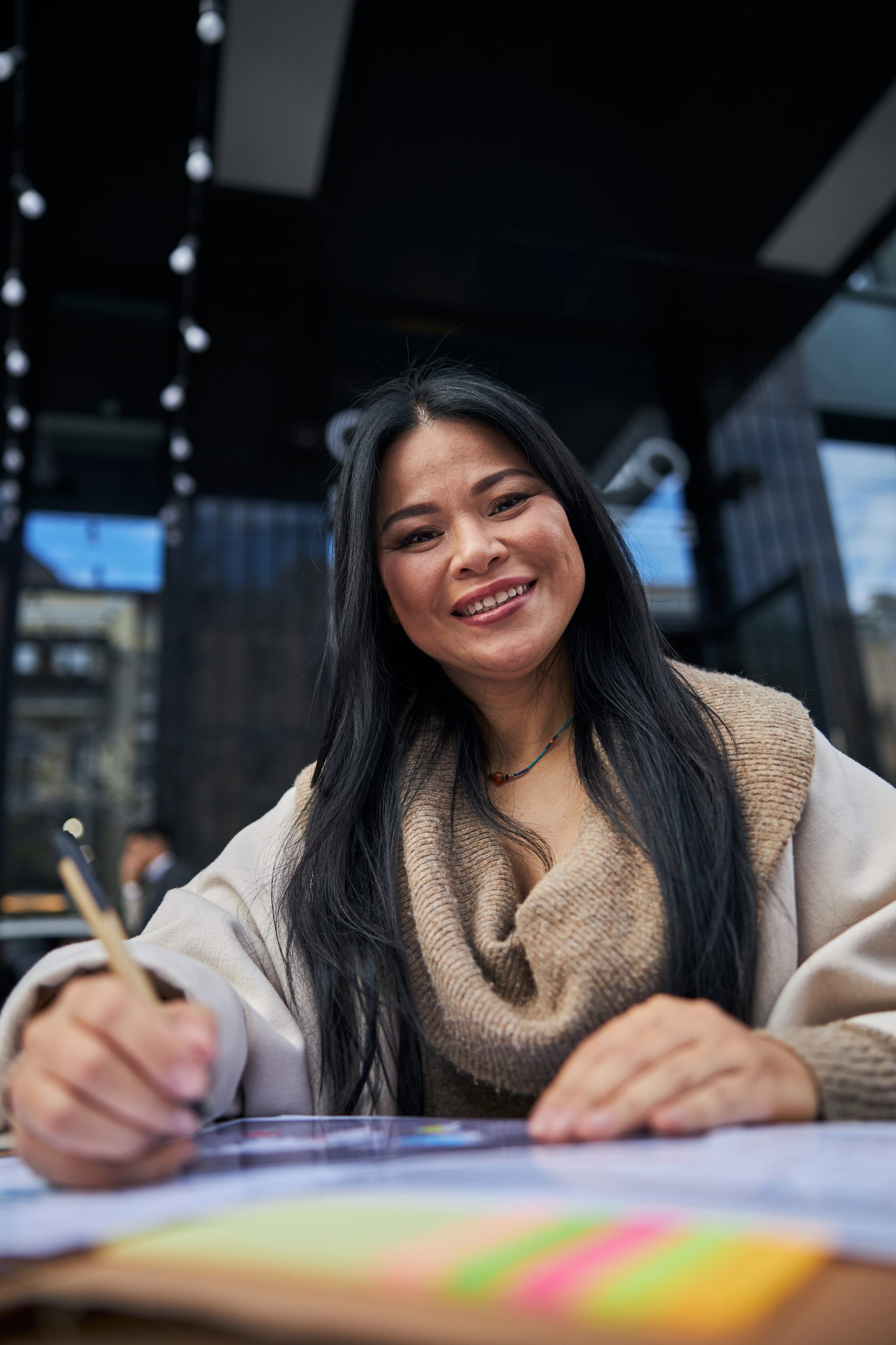 Beautiful woman working with documents in outdoors cafe